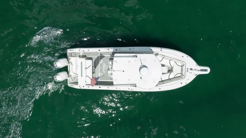 Slide: The Image of Aerial view of a 2000 Pursuit 2870 Center Console boat on green water. - 4