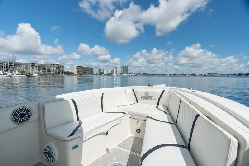 Slide: The Image of 2000 Pursuit 2870 Center Console boat with white seating on calm water. - 8