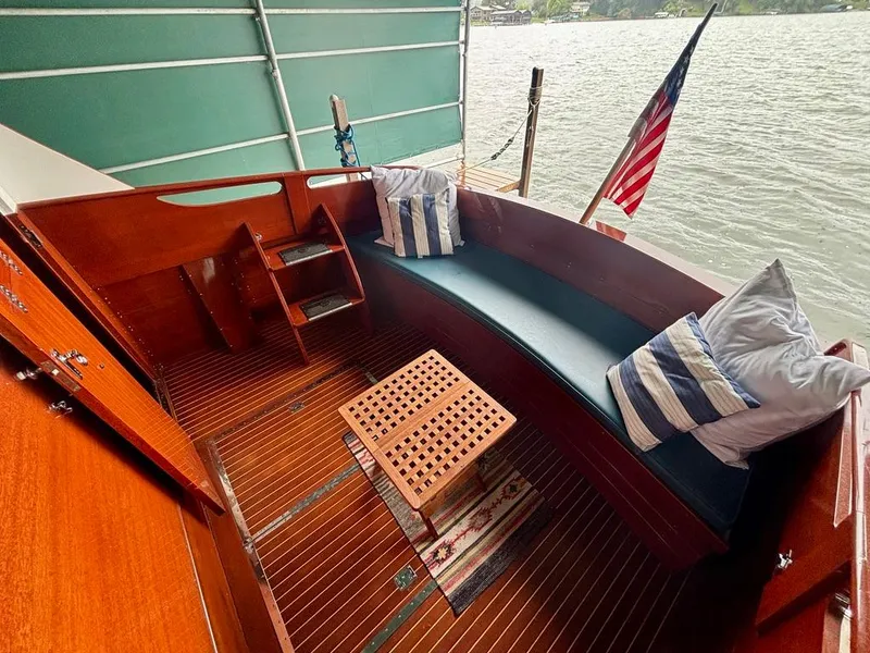 Slide: The Image of 1954 Chris-Craft Sedan Cruiser interior with wooden seating, cushions, and American flag. - 4