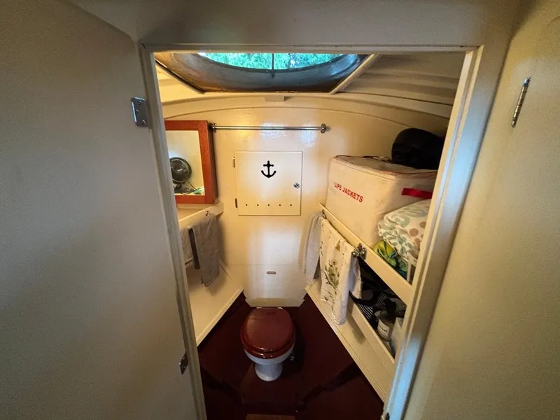 Slide: The Image of 1954 Chris-Craft Sedan Cruiser bathroom with porthole, towels, and life jackets. - 7