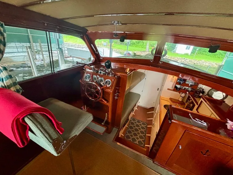 Slide: The Image of 1954 Chris-Craft Sedan Cruiser interior with vintage helm, wooden details, and cozy cabin space. - 8
