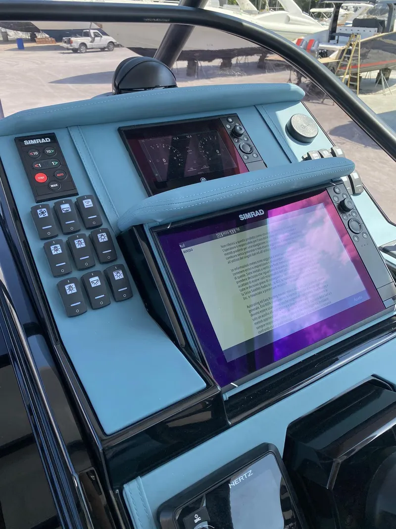 Slide: The Image of Control panel of the 2025 Ranieri CAYMAN 38.0 EXECUTIVE boat with Simrad displays. - 13