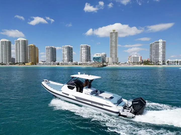 Slide: The Image of 2025 Ranieri CAYMAN 38.0 EXECUTIVE cruising near a city skyline on a sunny day. - 7