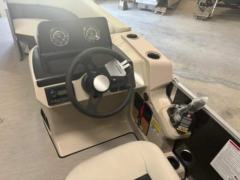 Slide: The Image of 2025 Harris Breeze 210 boat dashboard with steering wheel and control panel. - 5