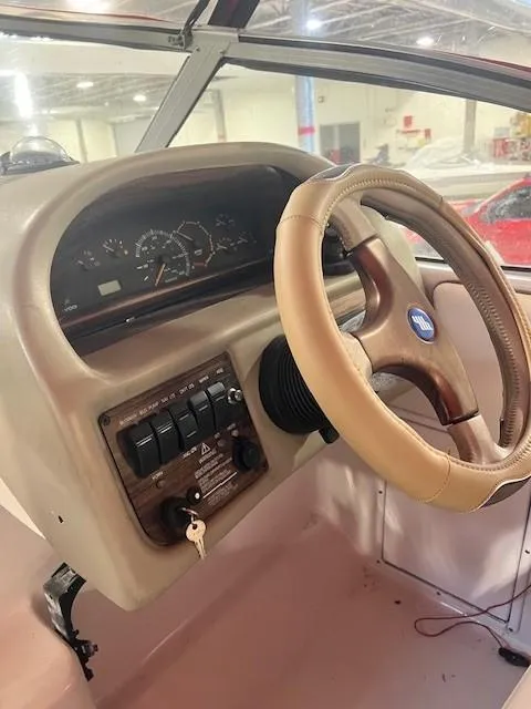 Slide: The Image of 1999 Four Winns 258 Vista boat dashboard with steering wheel and control panel. - 3