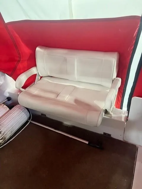 Slide: The Image of 1999 Four Winns 258 Vista boat interior with white seating and red accents. - 6