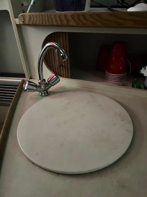 Slide: The Image of 1999 Four Winns 258 Vista boat sink with faucet and countertop. - 8