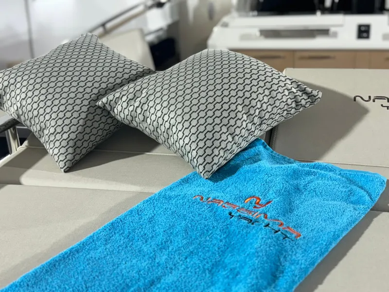 Slide: The Image of Nassima Yacht N40 2025 model with cushions and branded blue towel on deck. - 19