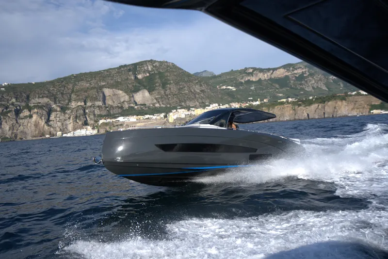 Slide: The Image of Nassima Yacht N40 2025 cruising on the ocean with scenic mountain backdrop. - 3