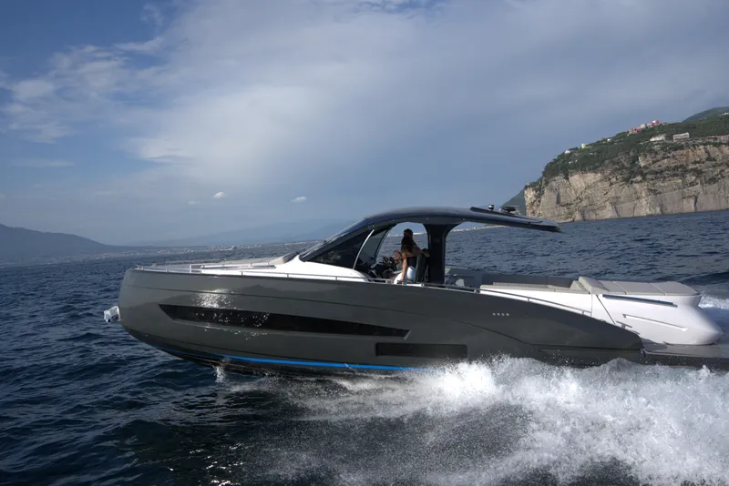 Slide: The Image of Nassima Yacht N40 2025 cruising on open water near rocky coastline. - 6