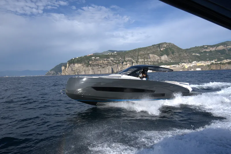Slide: The Image of Nassima Yacht N40 2025 cruising on the ocean near rocky coastline. - 7