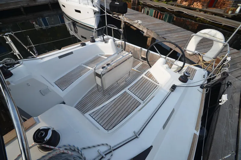 Slide: The Image of 2015 Jeanneau 349 sailboat cockpit with wooden deck, docked at marina. - 10