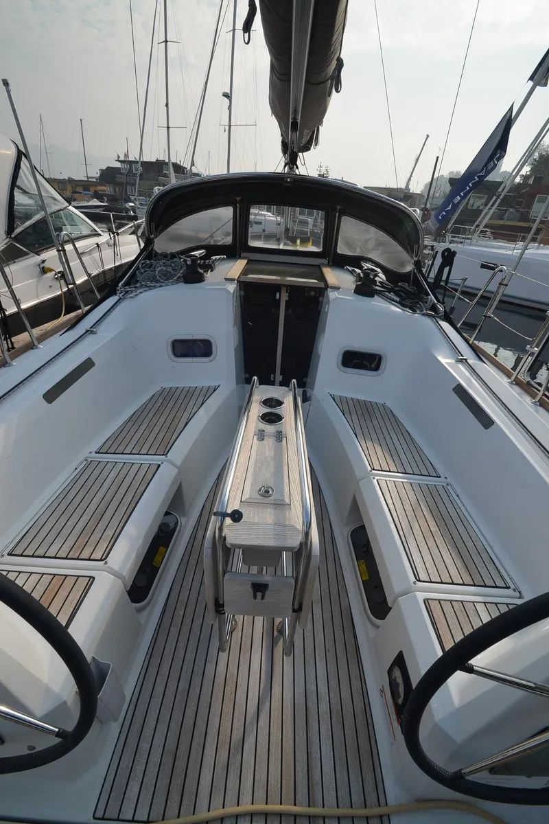 Slide: The Image of 2015 Jeanneau 349 sailboat cockpit with sleek design and wooden seating. - 13