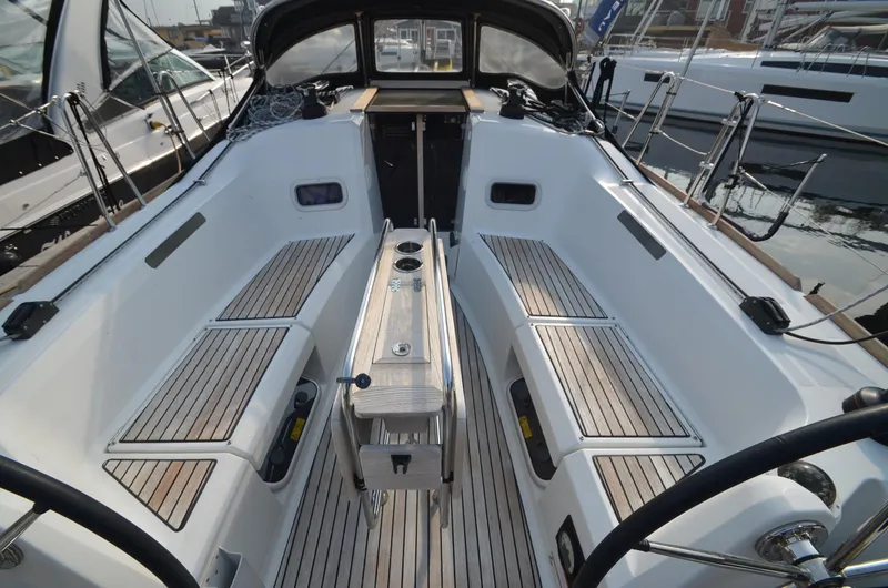 Slide: The Image of 2015 Jeanneau 349 sailboat cockpit with teak seating and dual steering wheels. - 14