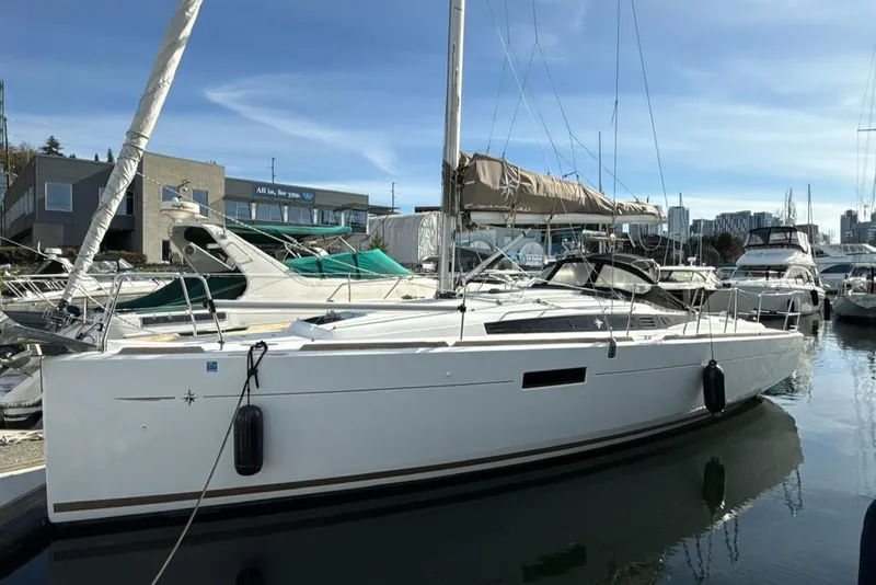 Slide: The Image of 2015 Jeanneau 349 sailboat docked in marina, clear sky, calm water. - 16