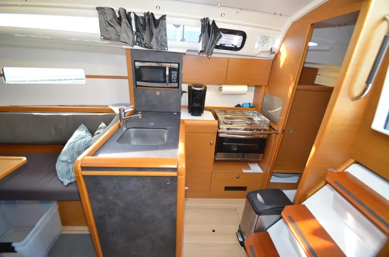 Slide: The Image of Interior of 2015 Jeanneau 349 sailboat with modern kitchen and seating area. - 19