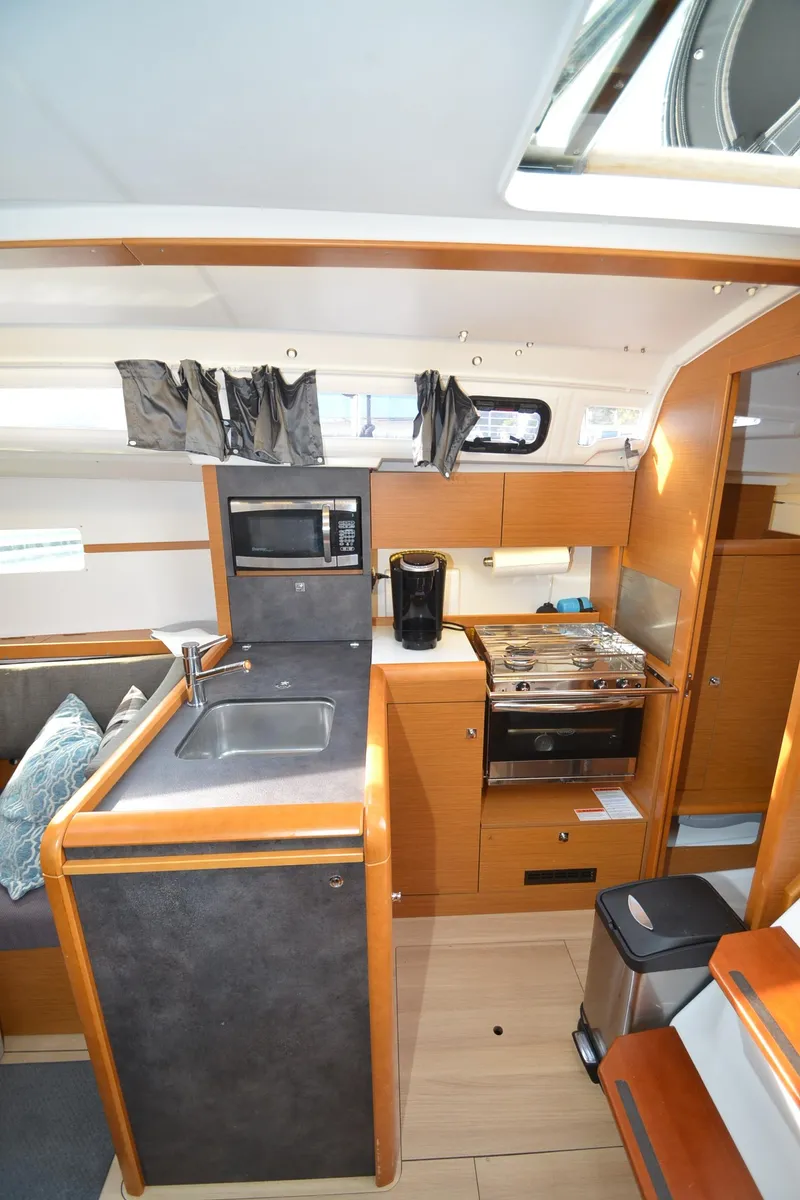 Slide: The Image of Interior of 2015 Jeanneau 349 sailboat with modern kitchen amenities. - 20
