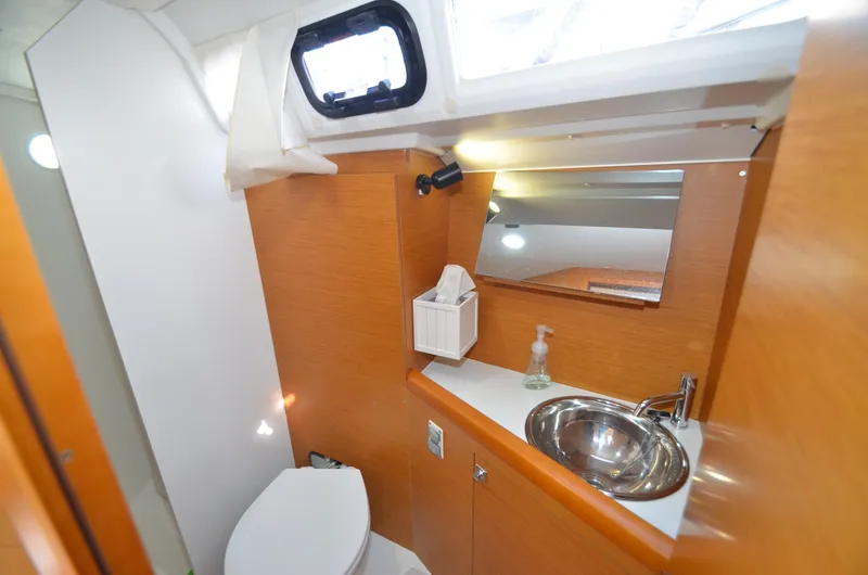 Slide: The Image of 2015 Jeanneau 349 yacht bathroom with sink, mirror, and toilet. - 24