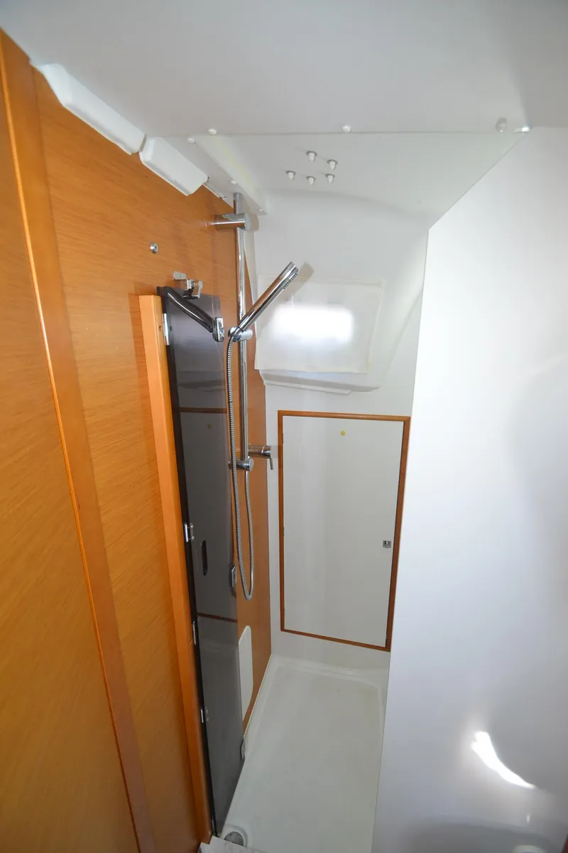 Slide: The Image of 2015 Jeanneau 349 bathroom with modern shower and wooden accents. - 26