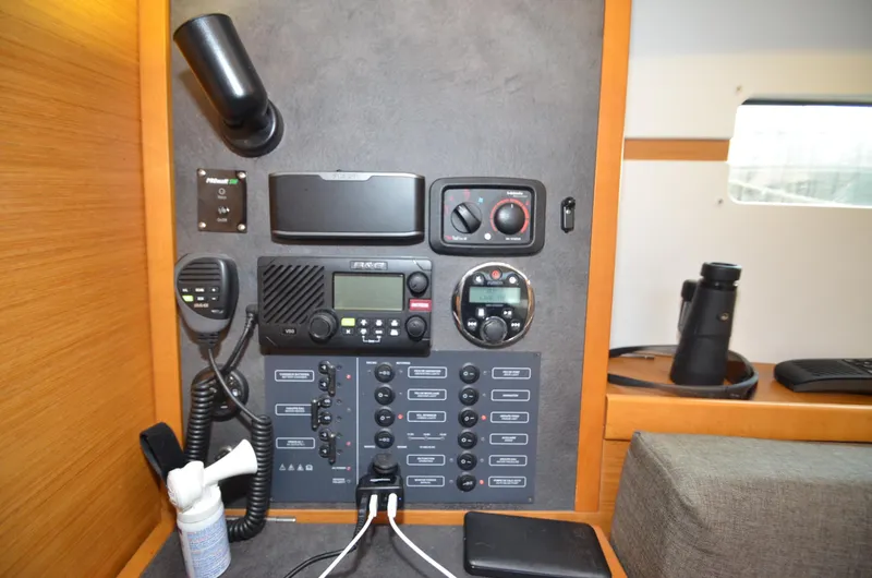 Slide: The Image of Control panel of a 2015 Jeanneau 349 sailboat with communication equipment and switches. - 32