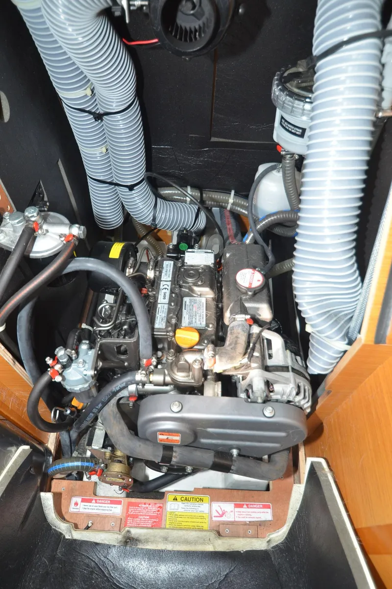 Slide: The Image of Engine compartment of a 2015 Jeanneau 349 sailboat, showcasing detailed mechanical components. - 33