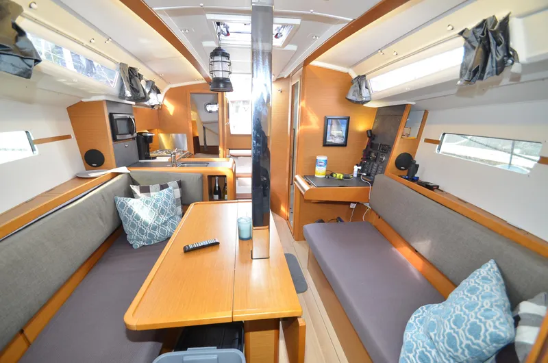Slide: The Image of Interior of 2015 Jeanneau 349 sailboat with cozy seating and modern amenities. - 4
