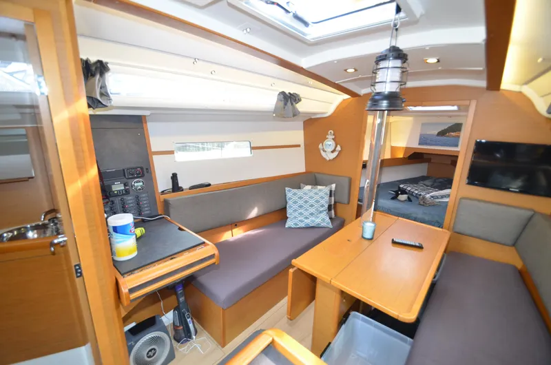 Slide: The Image of Interior of 2015 Jeanneau 349 sailboat with cozy seating and dining area. - 5
