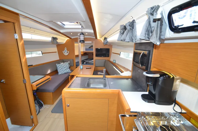Slide: The Image of Interior of 2015 Jeanneau 349 sailboat with modern kitchen and seating area. - 7