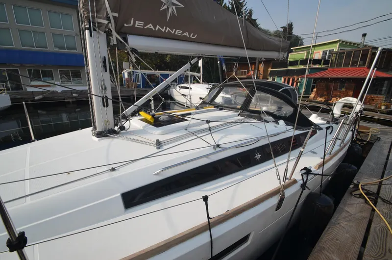 Slide: The Image of 2015 Jeanneau 349 sailboat docked at marina, showcasing sleek design and modern features. - 8
