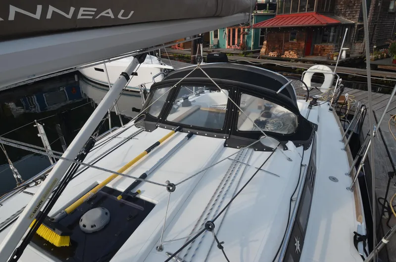Slide: The Image of 2015 Jeanneau 349 sailboat docked, featuring sleek design and modern rigging. - 9