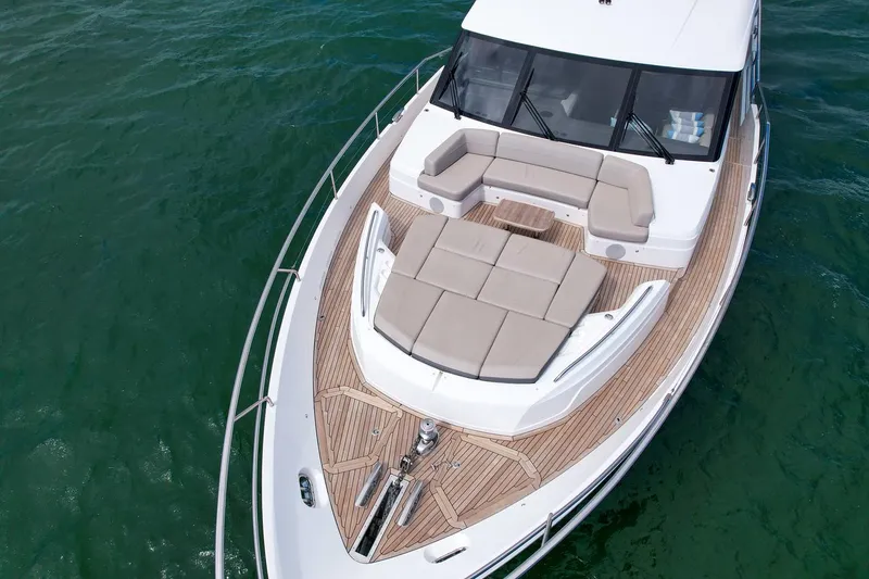 Slide: The Image of Princess Y78 2021 yacht with spacious deck and seating area on calm water. - 10