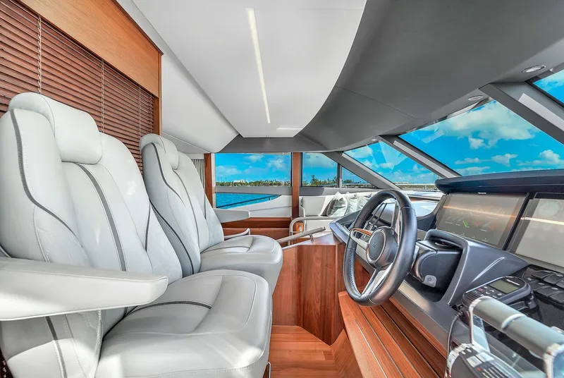 Slide: The Image of Luxurious helm of the 2021 Princess Y78 yacht with leather seats and panoramic windows. - 35