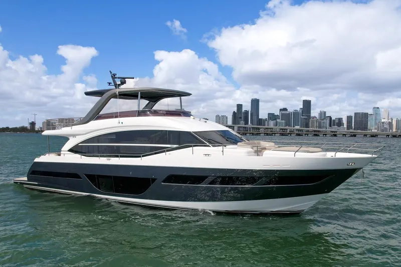Slide: The Image of Luxury 2021 Princess Y78 yacht cruising near city skyline on a sunny day. - 4