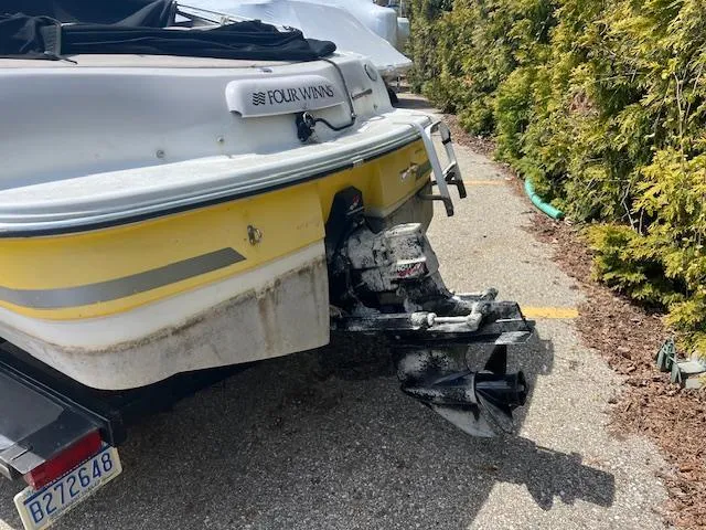 Slide: The Image of 2003 Four Winns 180 Freedom I/O boat, rear view with outboard motor. - 3