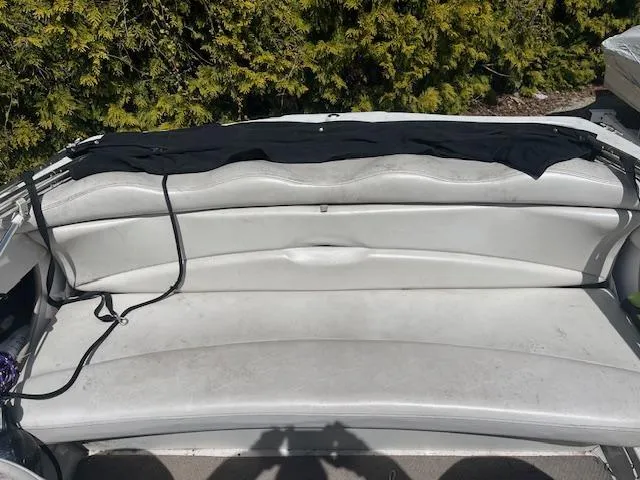 Slide: The Image of 2003 Four Winns 180 Freedom I/O boat interior seating with black cover. - 7