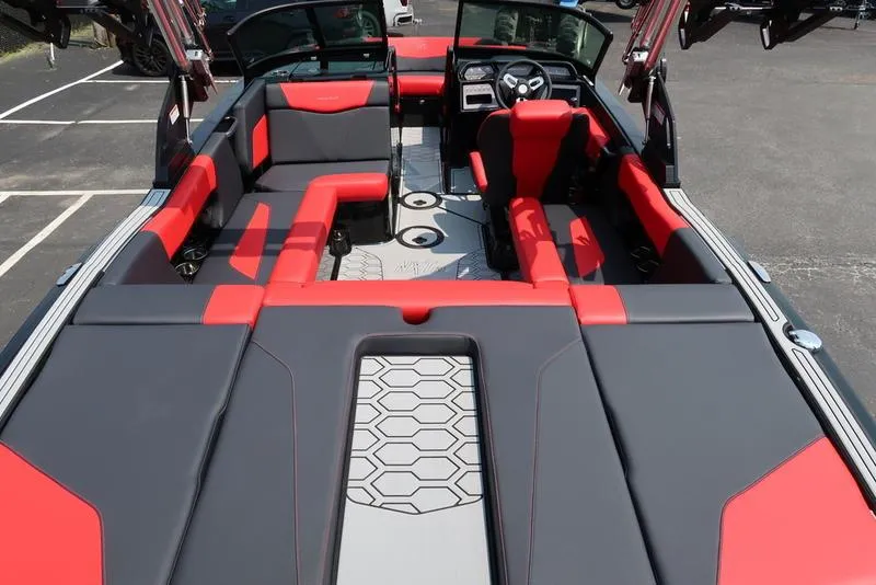 Slide: The Image of 2025 MasterCraft NXT20 boat interior with red and gray seating, modern design. - 11