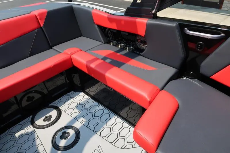 Slide: The Image of 2025 MasterCraft NXT20 interior with red and gray seating, hexagonal floor pattern. - 15