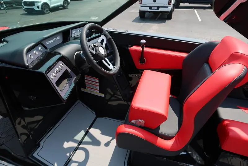 Slide: The Image of Interior of 2025 MasterCraft NXT20 boat with red and black seating. - 19