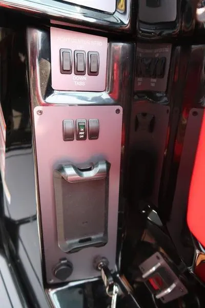 Slide: The Image of Control panel of 2025 MasterCraft NXT20 boat with switches and cup holder. - 20