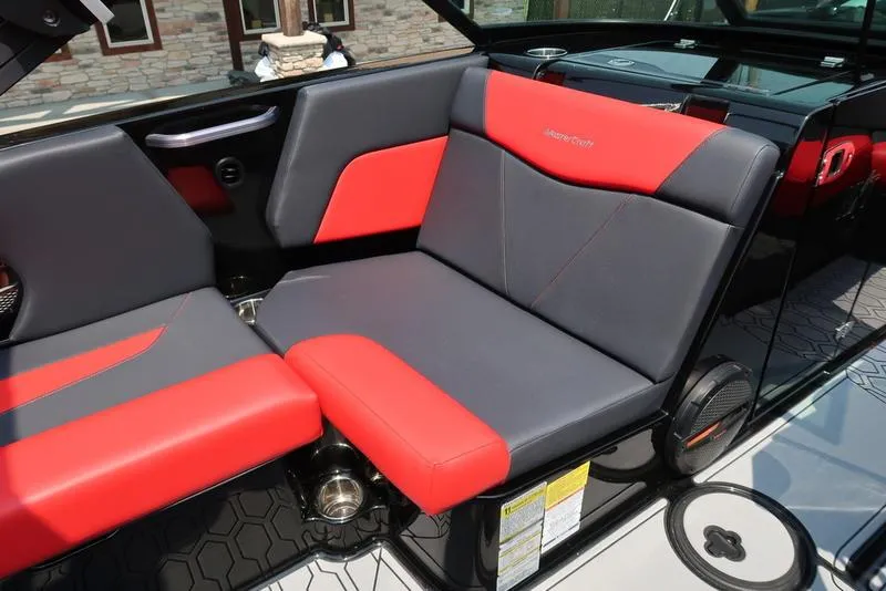 Slide: The Image of 2025 MasterCraft NXT20 boat interior with red and gray seating, modern design. - 21
