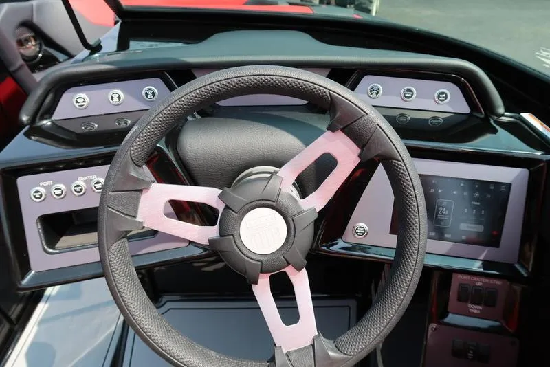 Slide: The Image of Steering wheel and dashboard of 2025 MasterCraft NXT20 boat, featuring modern controls. - 25