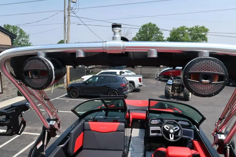Slide: The Image of 2025 MasterCraft NXT20 boat interior with advanced audio system in a parking lot. - 31