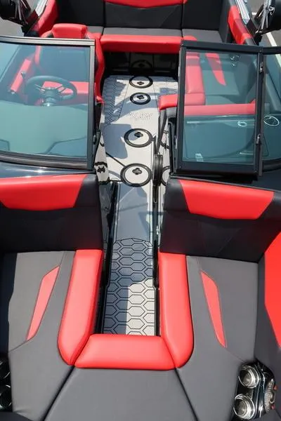 Slide: The Image of 2025 MasterCraft NXT20 boat interior with red and black seating and hexagonal floor design. - 35