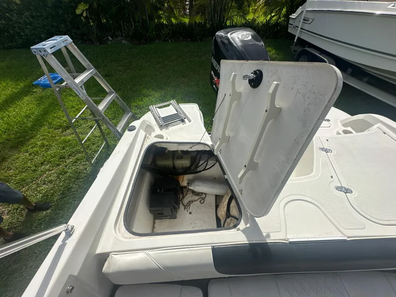 Slide: The Image of Open storage compartment on a 2016 Tahoe 550 TS boat. - 16