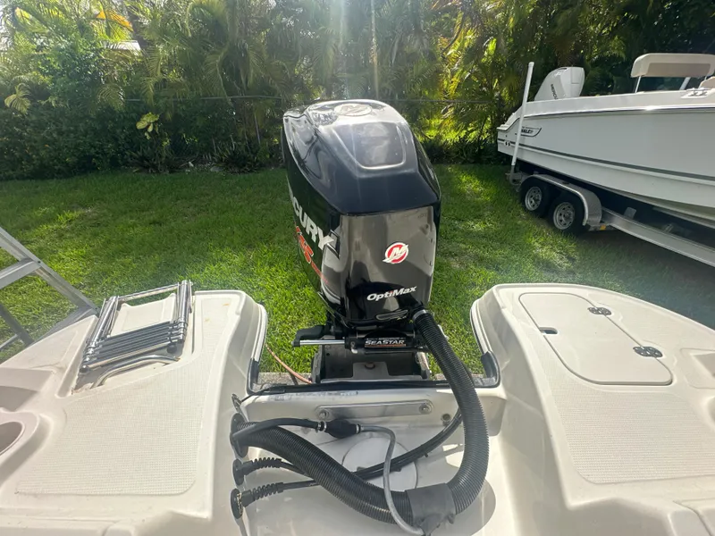 Slide: The Image of 2016 Tahoe 550 TS boat with Mercury OptiMax outboard motor in a grassy yard. - 17
