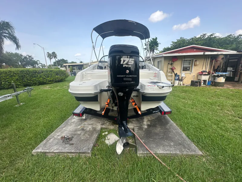 Slide: The Image of 2016 Tahoe 550 TS boat with 175 Pro motor in a backyard. - 3