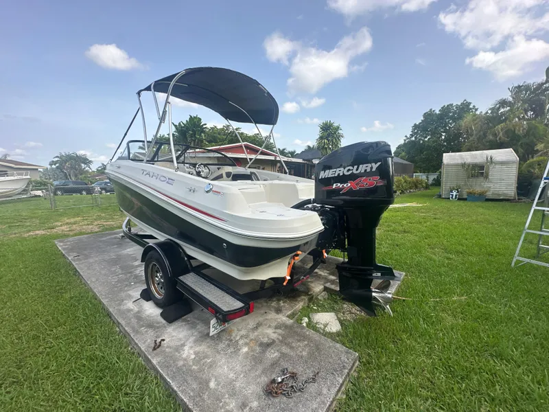 Slide: The Image of 2016 Tahoe 550 TS boat with Mercury engine on trailer in a yard. - 4