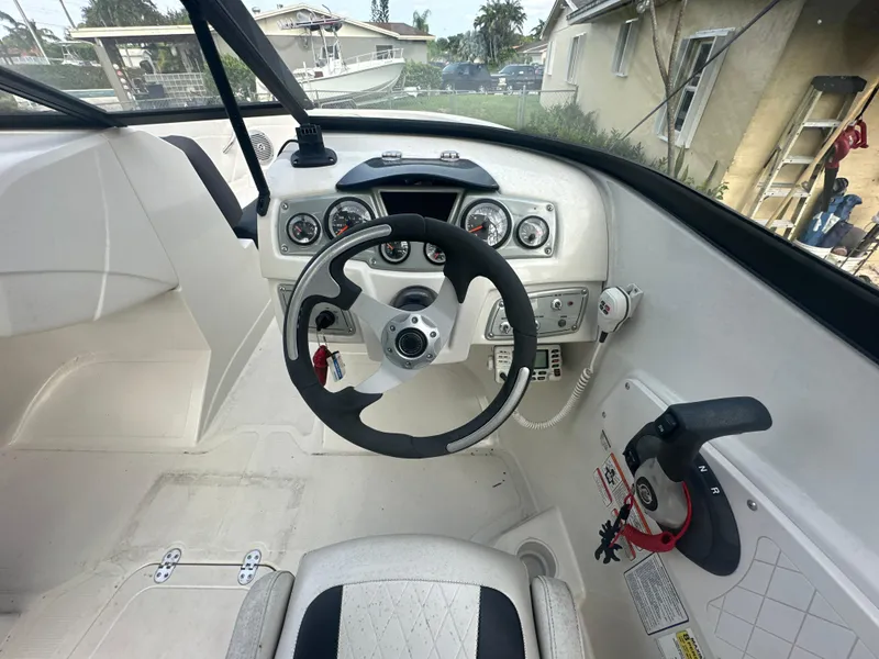 Slide: The Image of 2016 Tahoe 550 TS boat cockpit with steering wheel and control panel. - 8