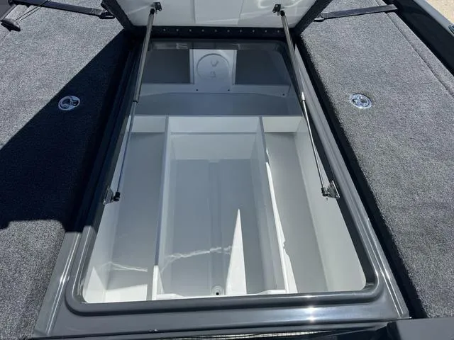 Slide: The Image of 2025 Phoenix Bass Boats 721 ZXL storage compartment with open lid. - 23