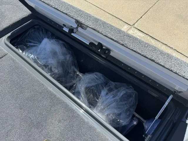 Slide: The Image of 2025 Phoenix Bass Boats 721 ZXL storage compartment with wrapped items. - 24